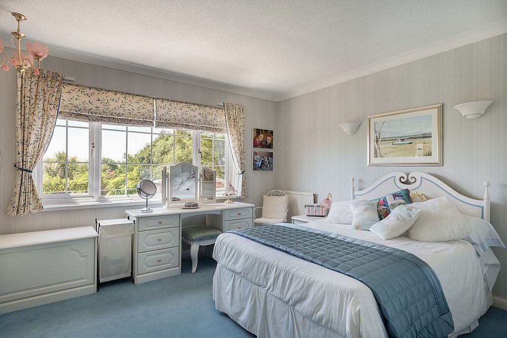 Traditional dresser and unique mirror create a makeup vanity that blends into the bedroom