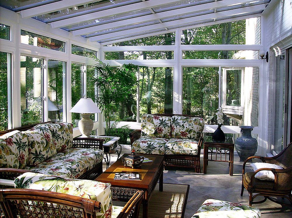 Tropical sunroom is drenched in green without an overload of indoor plants!