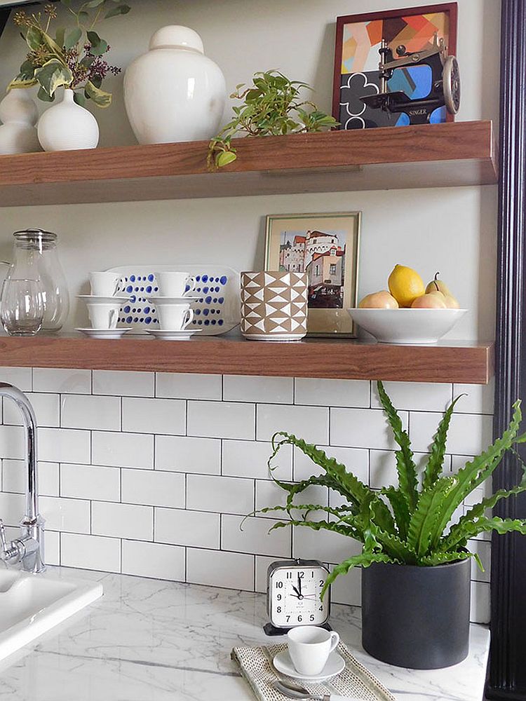 White tiled kitchen backsplash along with marble worktops