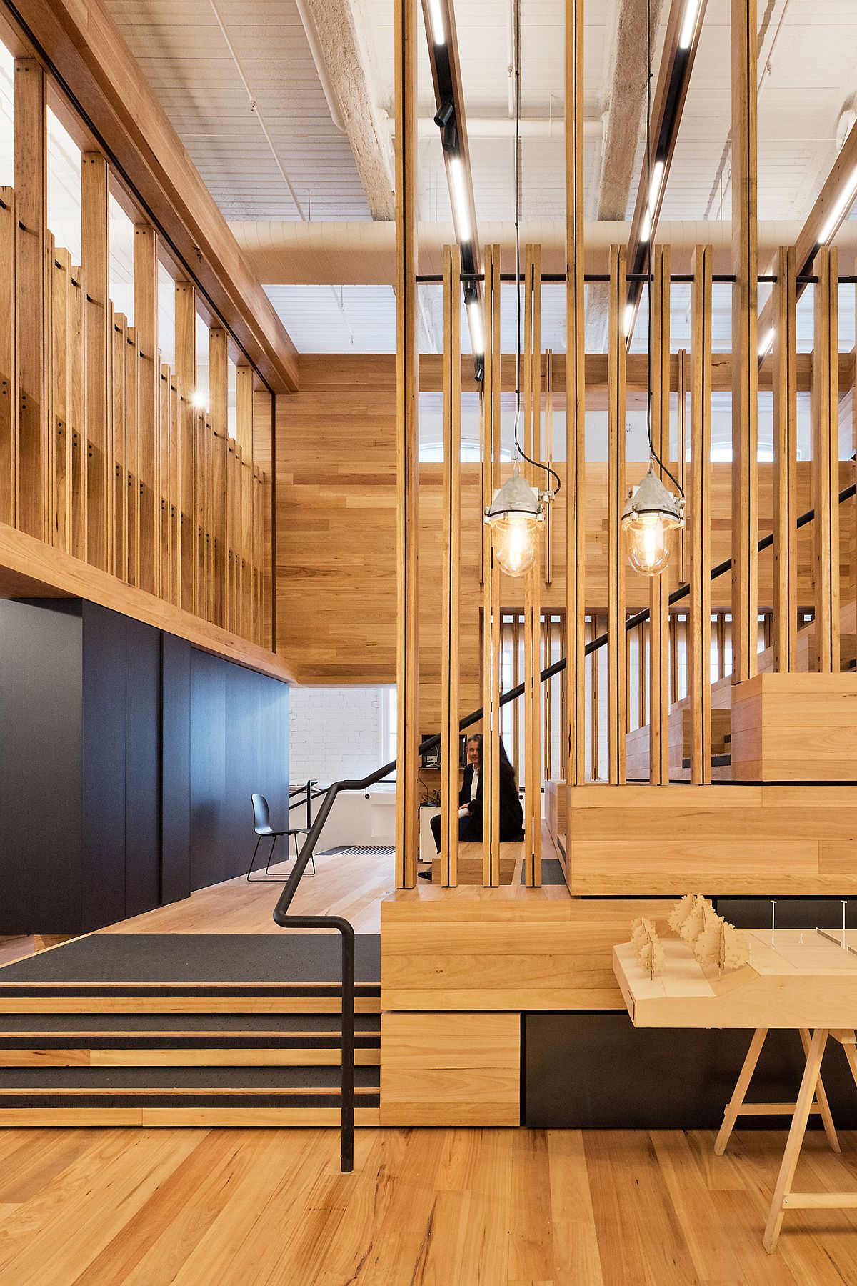 Wooden-slats-and-a-high-ceiling-give-the-office-a-modern-industrial-look