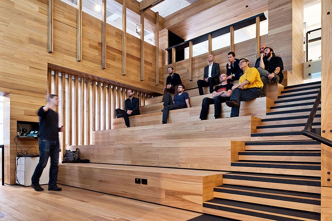 Wooden tiered platforms provide an informal seating zone inside the events space