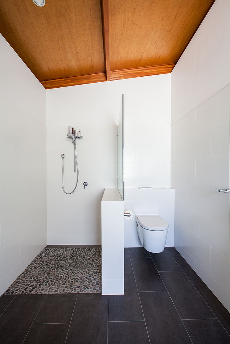 Black and white bathroom with sloped wooden ceiling