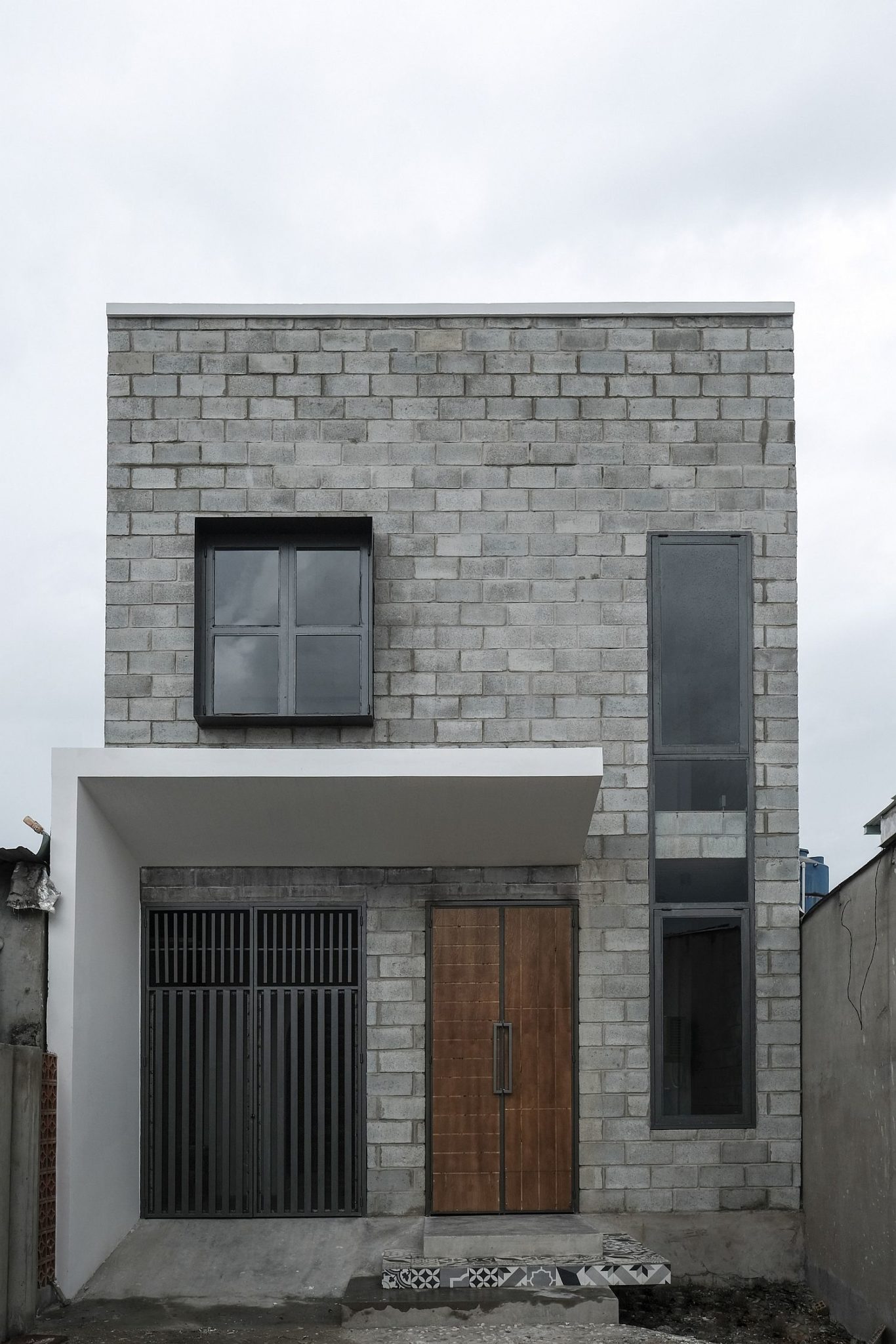 Concrete exterior of the home with wooden door