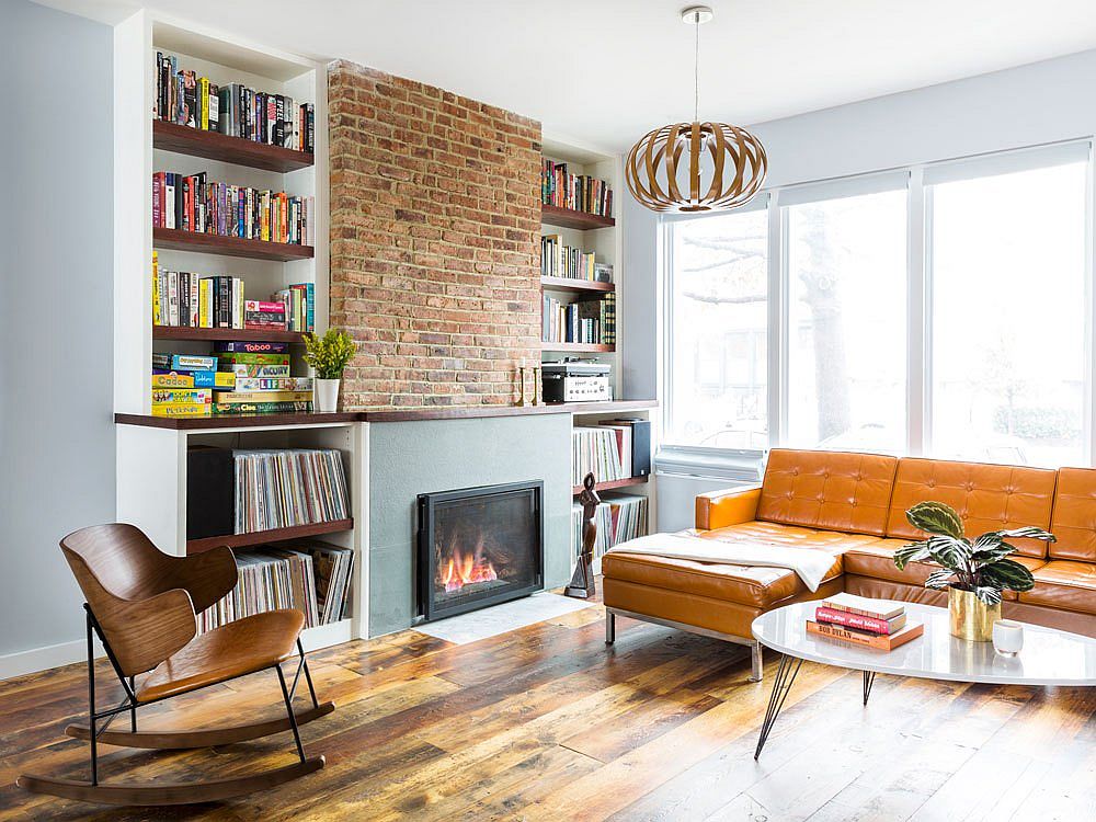 Custom shelves next to the brick wall section and fireplace holds vinyl records