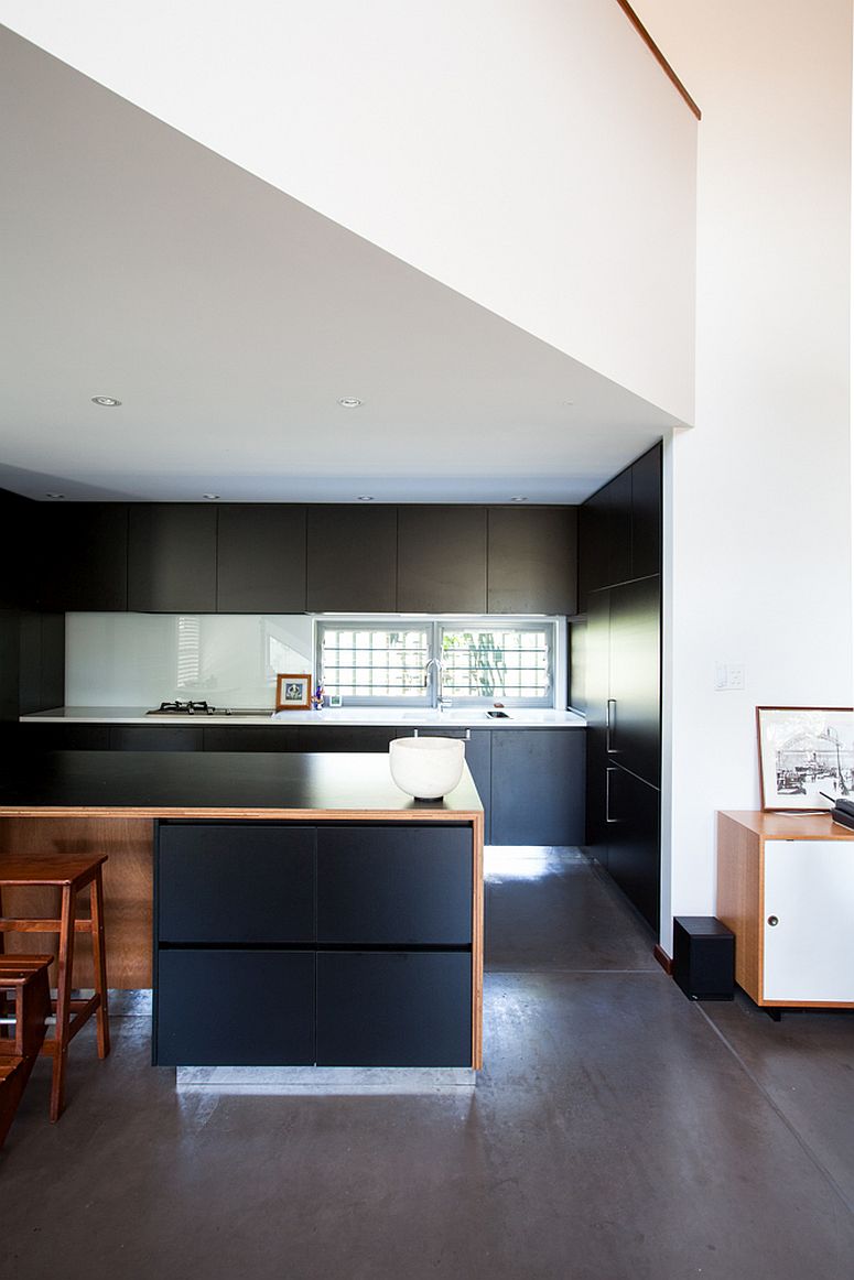 Dark cabinets of the kitchen present a contrasting image