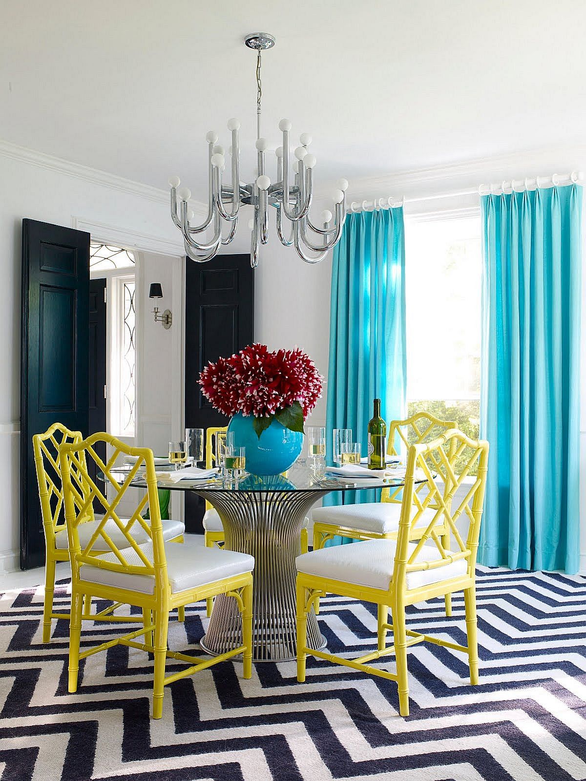 Eclectic modern dining room with bright yellow chairs and light blue drapes