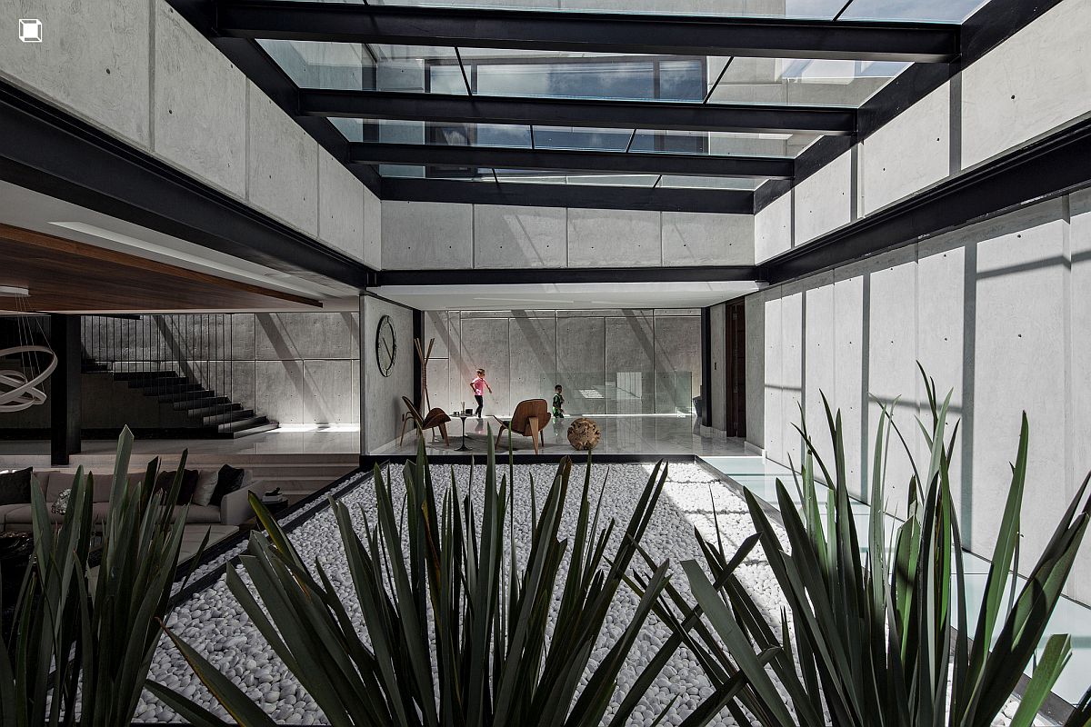Expansive covered terrace with glass roof connects the living area with kitchen and dining