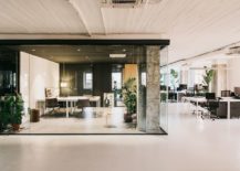 Exposed-concrete-pillars-and-glass-walls-shape-the-private-office-spaces-217x155