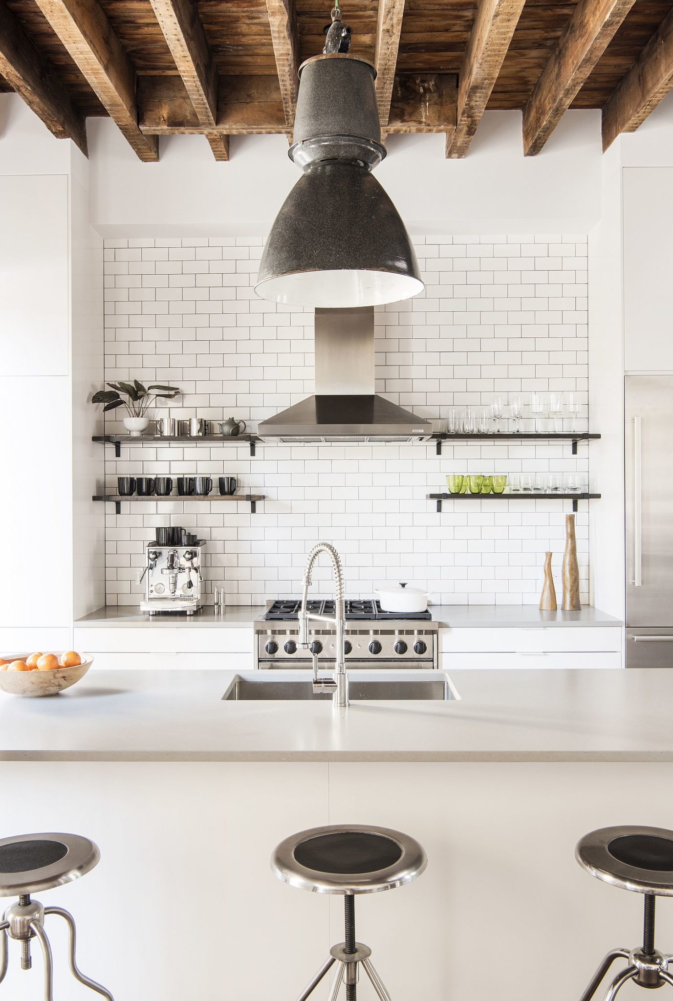 Exposed wooden ceiling and joint bring textural contrast to the new interior