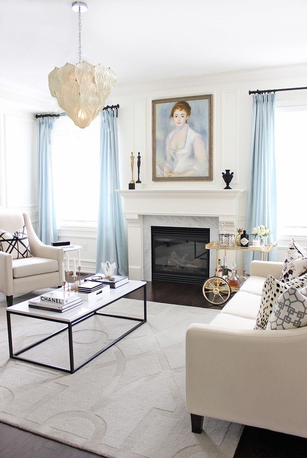 Exquisite living room in white with light blue drapes and French finesse