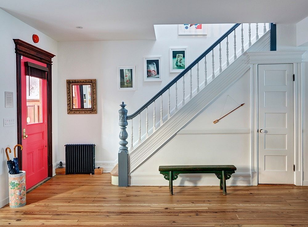 Front door of the refurbished row house in  bright pink with plenty of spunky