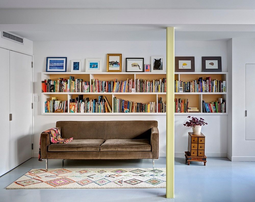 Functional wall delineates space while providing ample shelf space for books