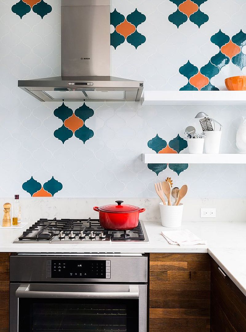 Glossy tiles in blue and orange bring color to the modern white kitchen