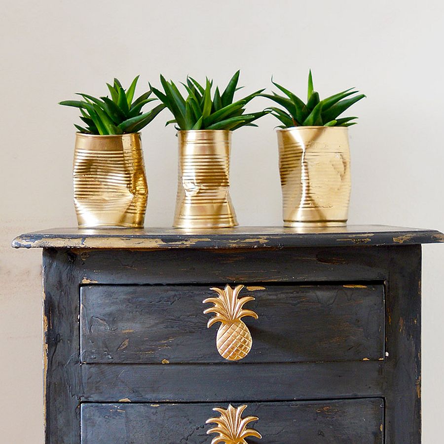 Gold DIY planters crafted using crushed tin cans