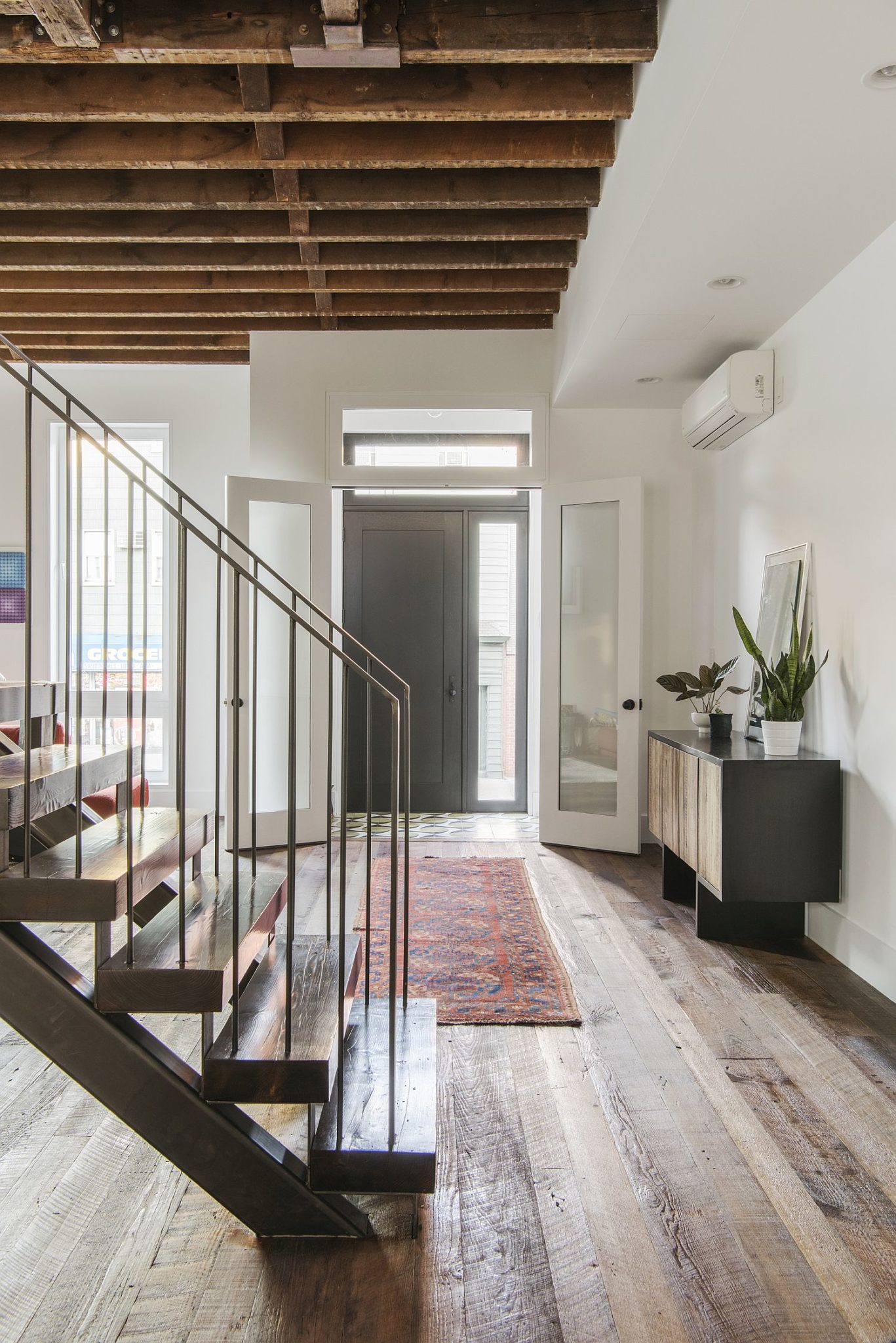 Gray door and a white backdrop provide a modern setting for the light-filled makeover