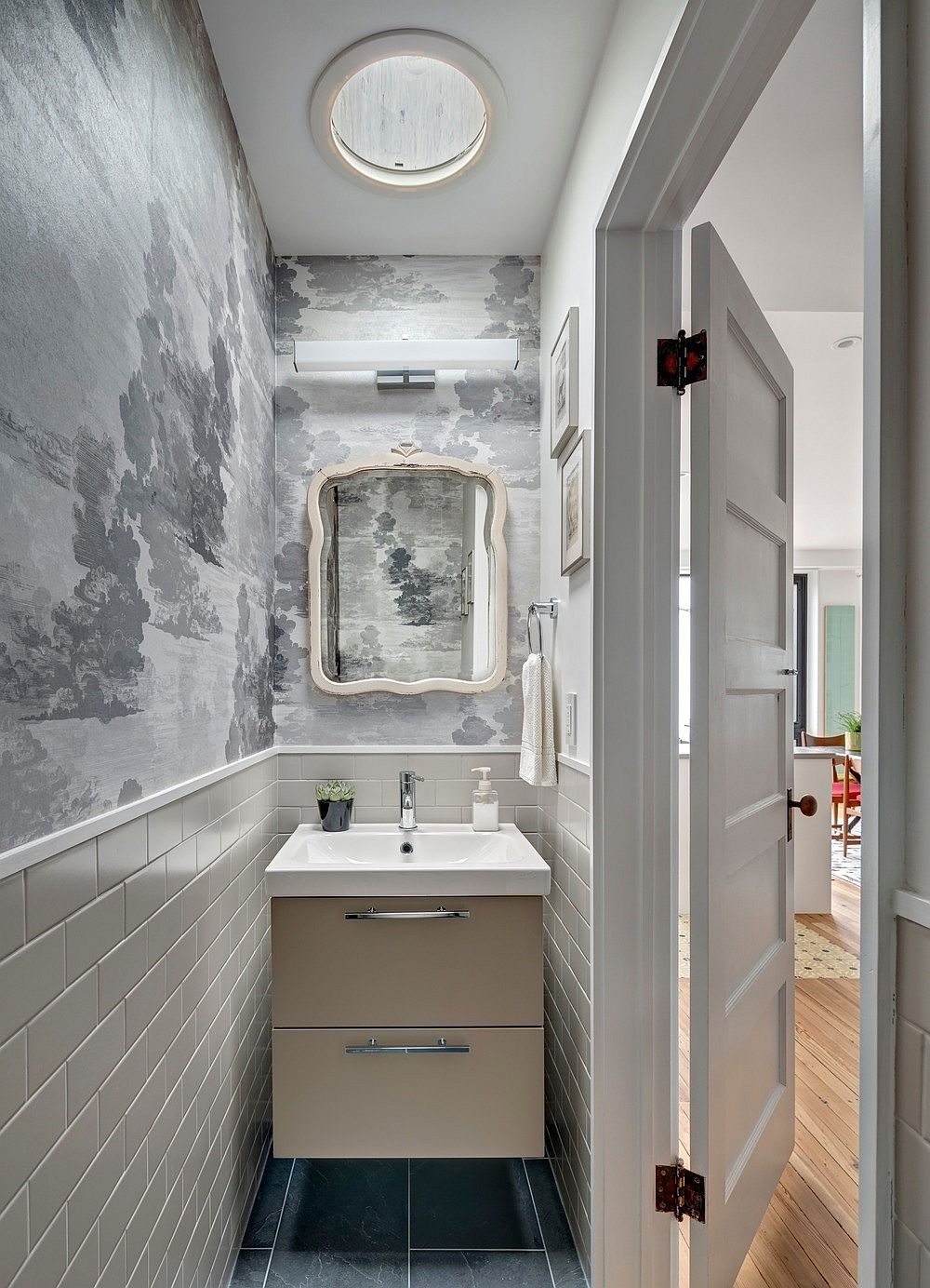 Gray powder room with walls that usher in whimsical charm