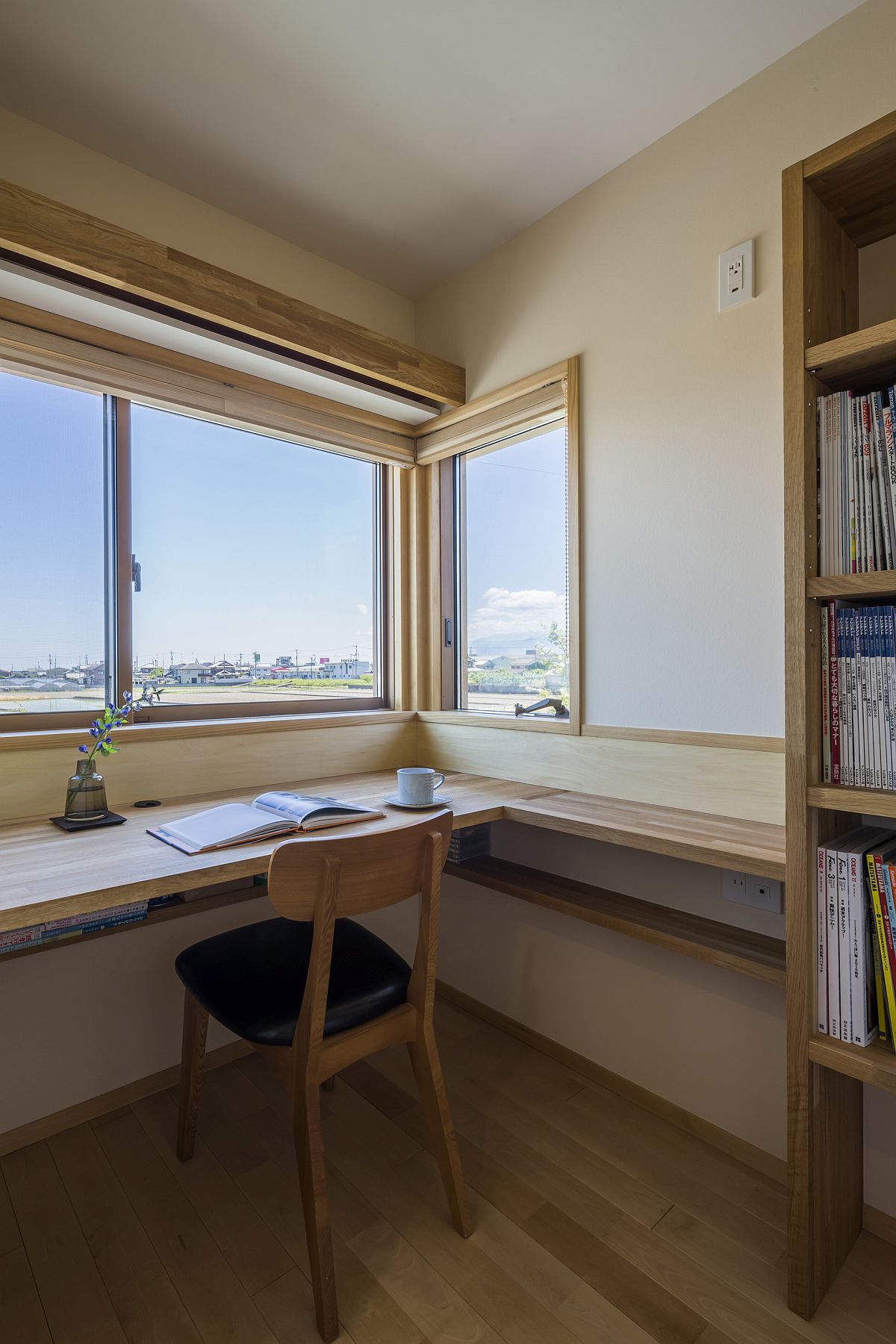 Home office with corner window that offers lovely view of the landscape