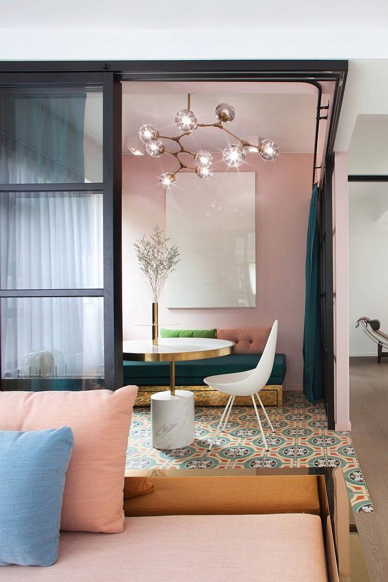 Jewel-toned green drapes and pastels create a gorgeous interior