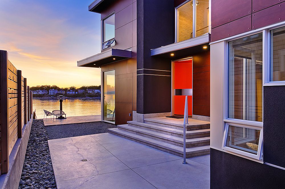 Lakeside home with a modern entry highlighted using a bold orange door