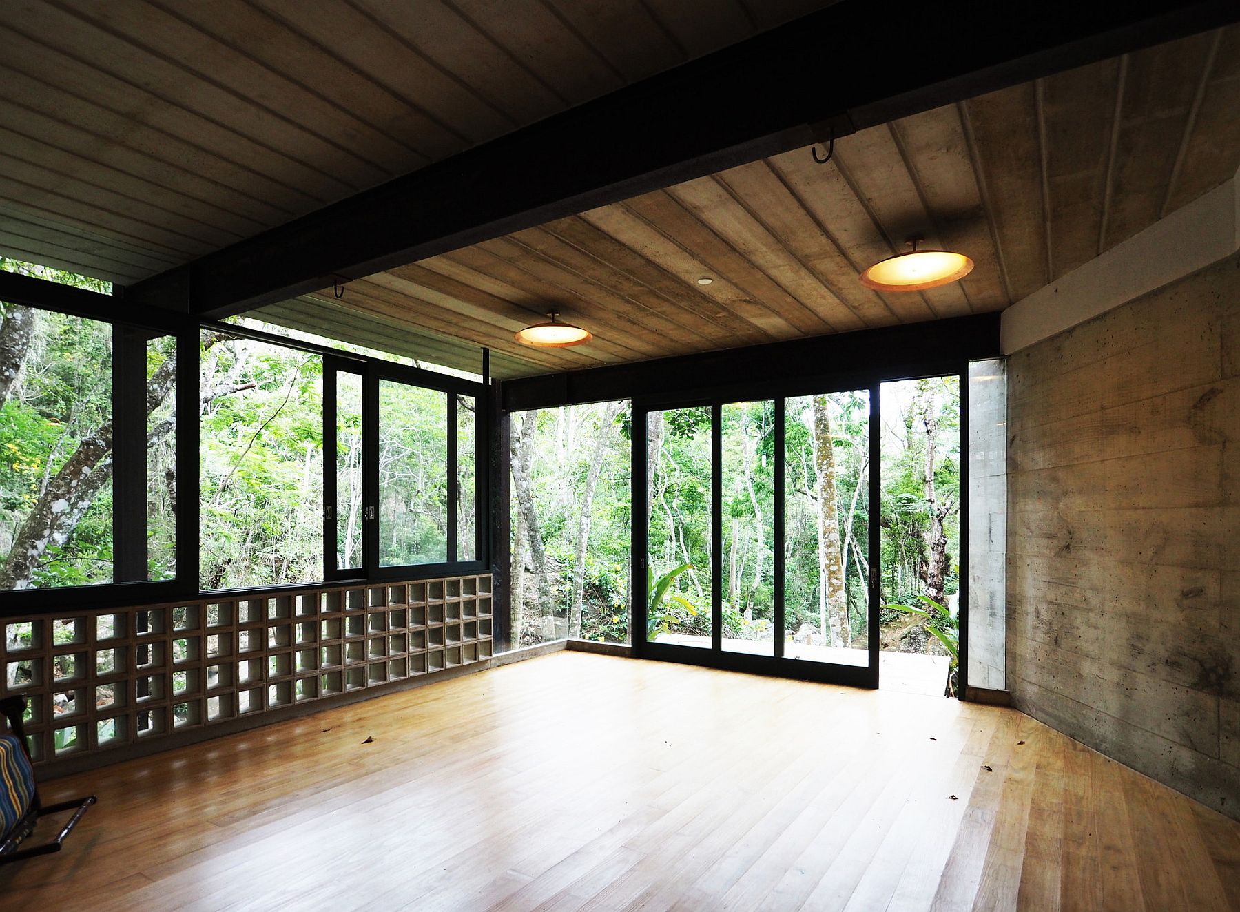 Large sliding glass doors and windows open the pavilion to the lovely view outside