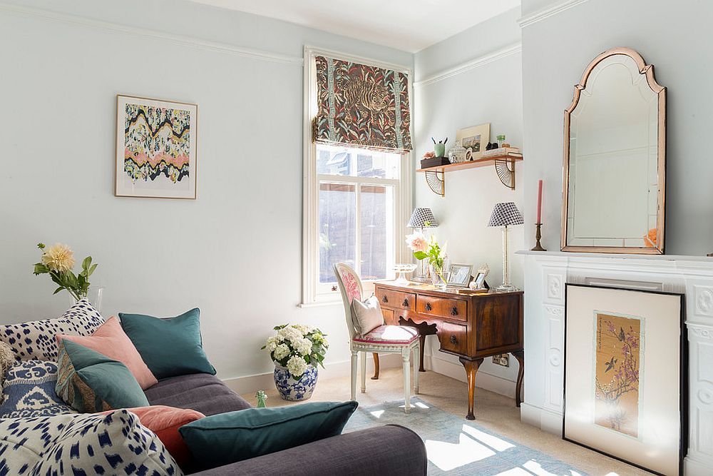 Light-filled home office in white with throw pillows bringing in pastel hues