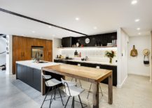 Light-filled-industrial-kitchen-with-concrete-floor-and-a-lovely-island-breakfast-bar-217x155