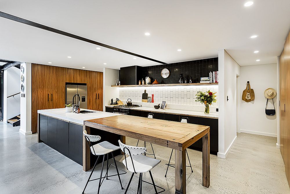 Light-filled industrial kitchen with concrete floor and a lovely island, breakfast bar