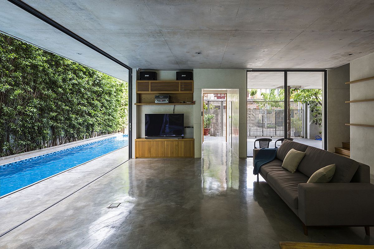 Living area and kitchen connected with the pool outside