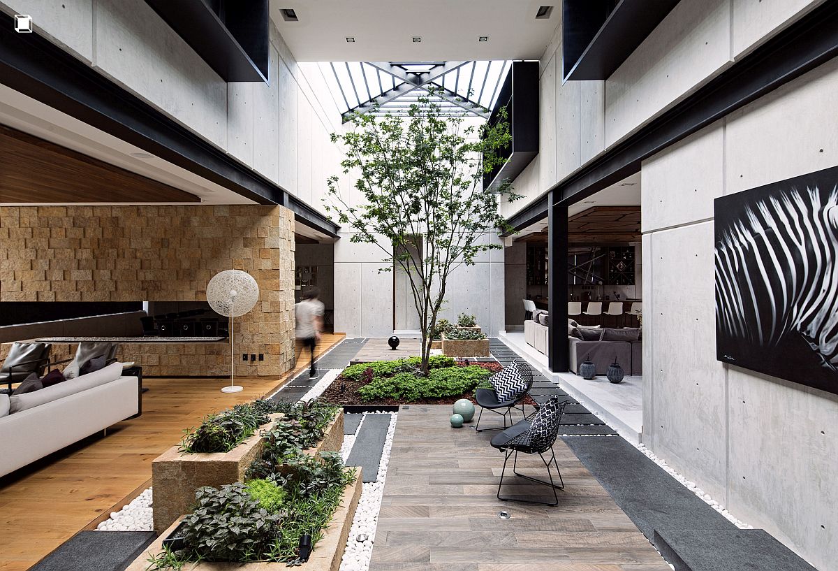 Living area of the Ro House connected with the double-height covered patio next to it