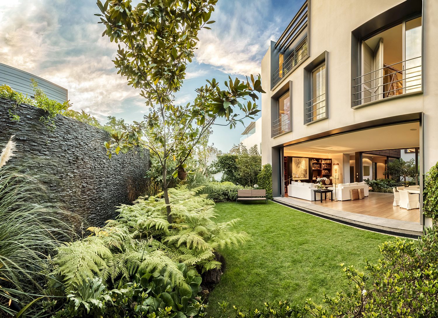 Lush green yard of private Mexican home becomes a part of interior