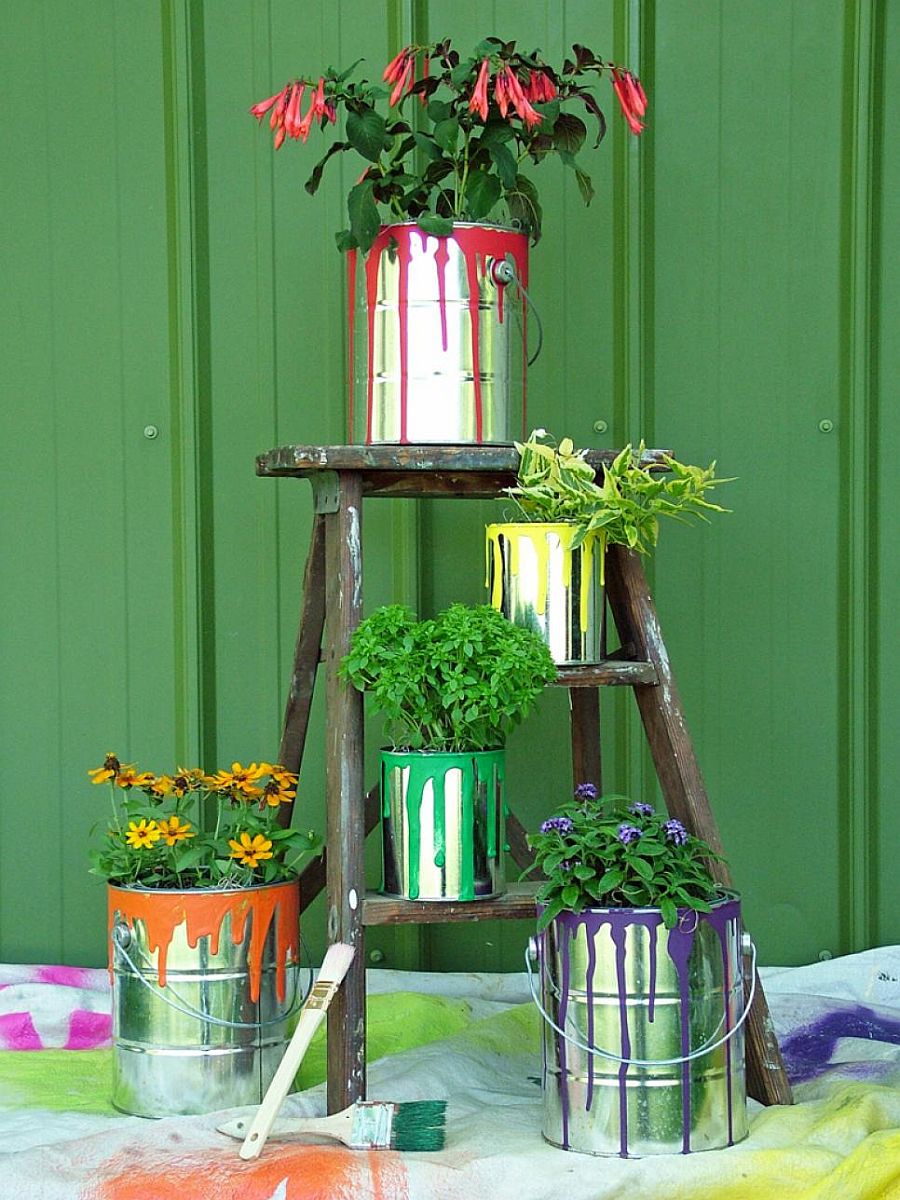 Old paint cans turned into planters bring both metallic dazzle and colorful zest