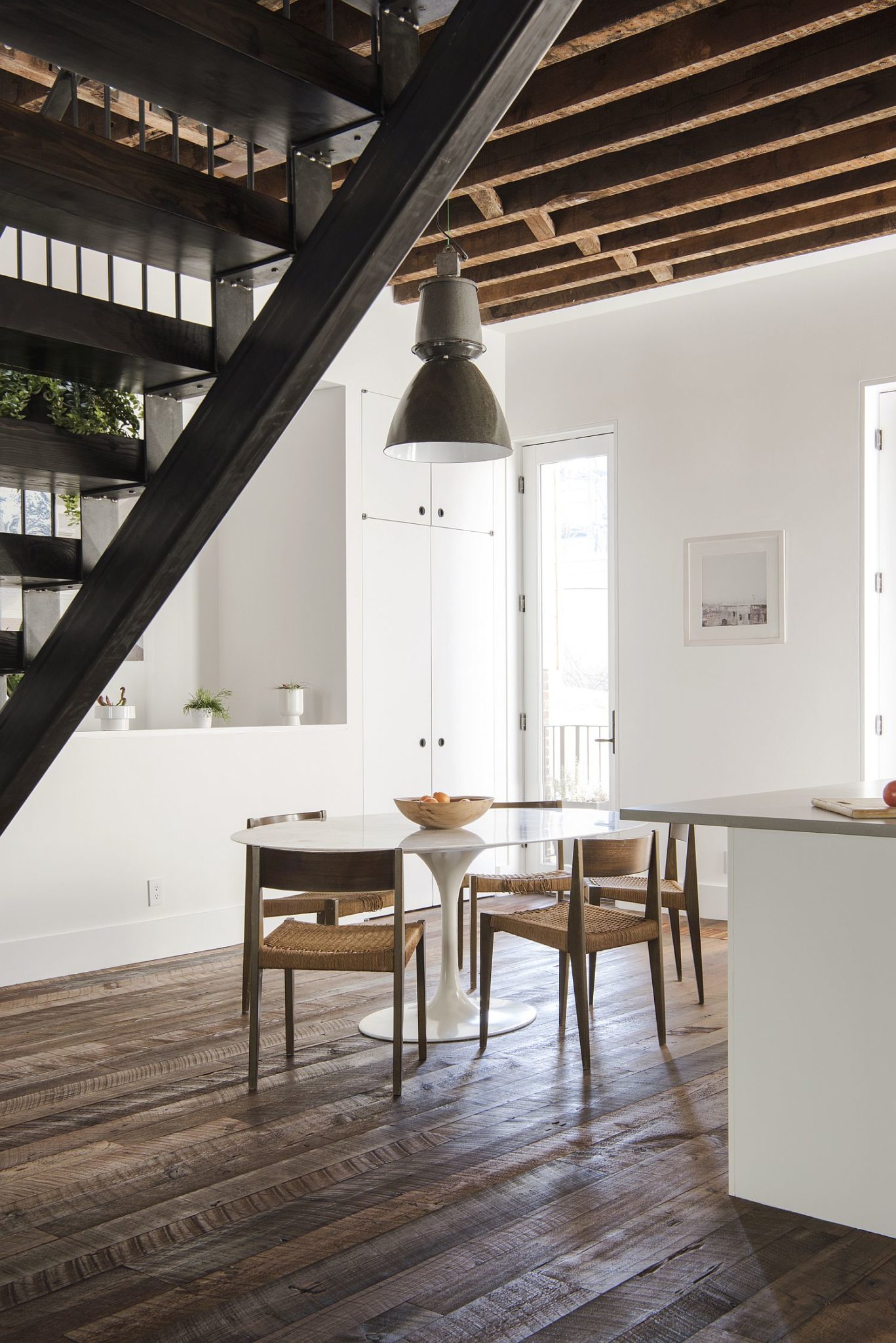 Oversized pendant light above the small dining space