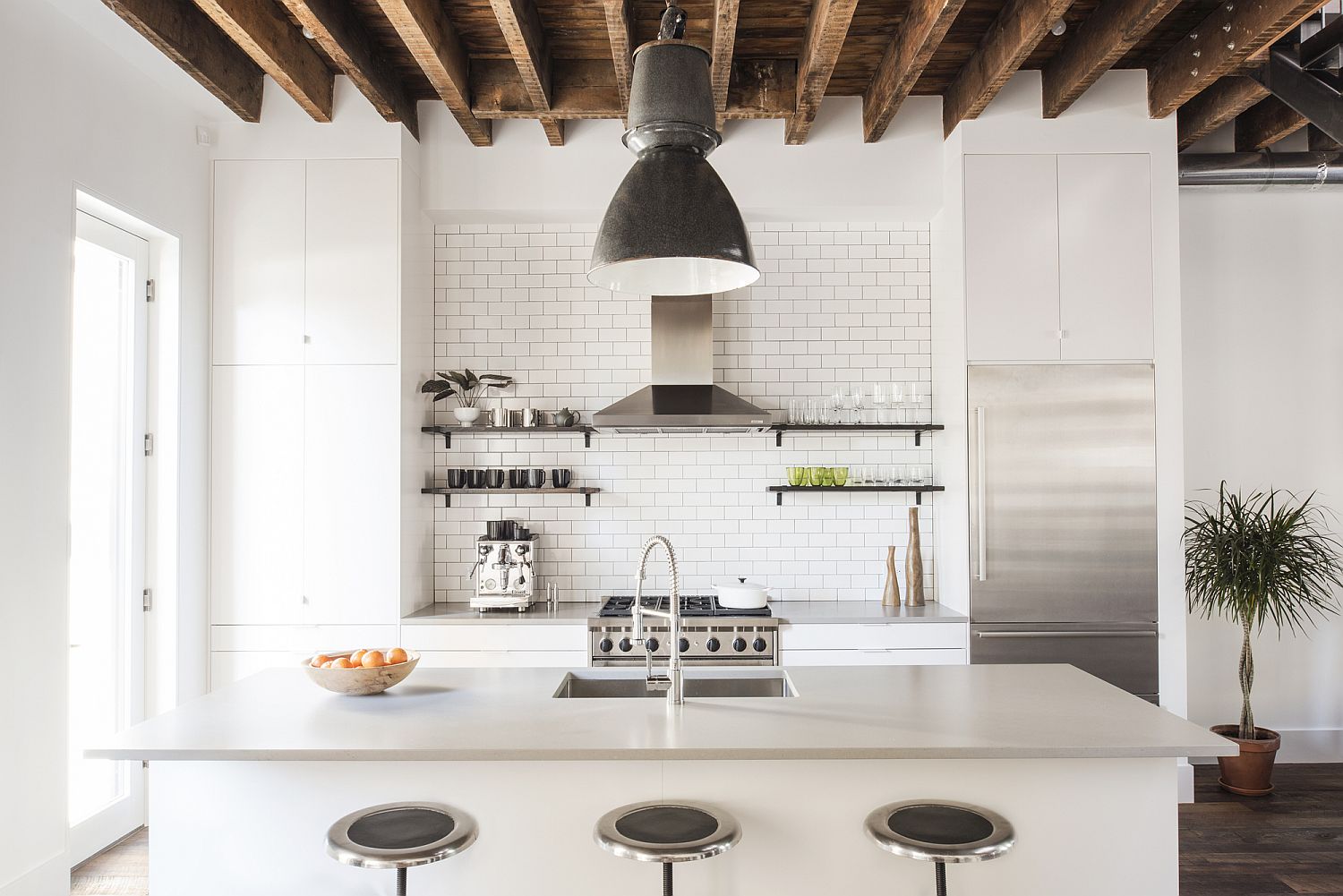 Oversized pendant light brings industrial elegance to the modern kitchen