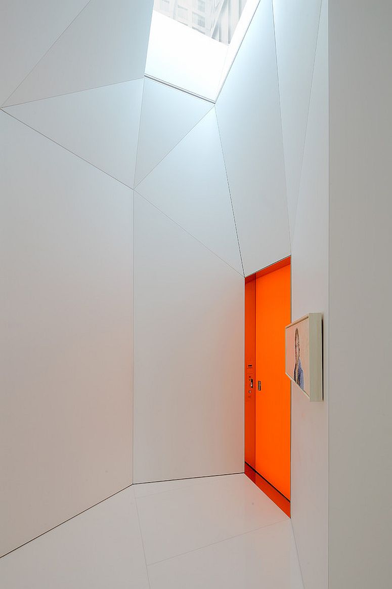 Polished contemporary exterior in white with bright orange door