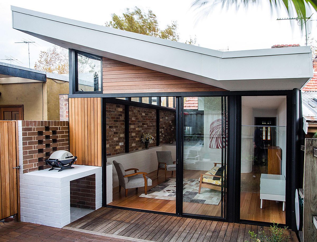 Recycled and exposed brick wall connects the interior with the rear courtyard visually