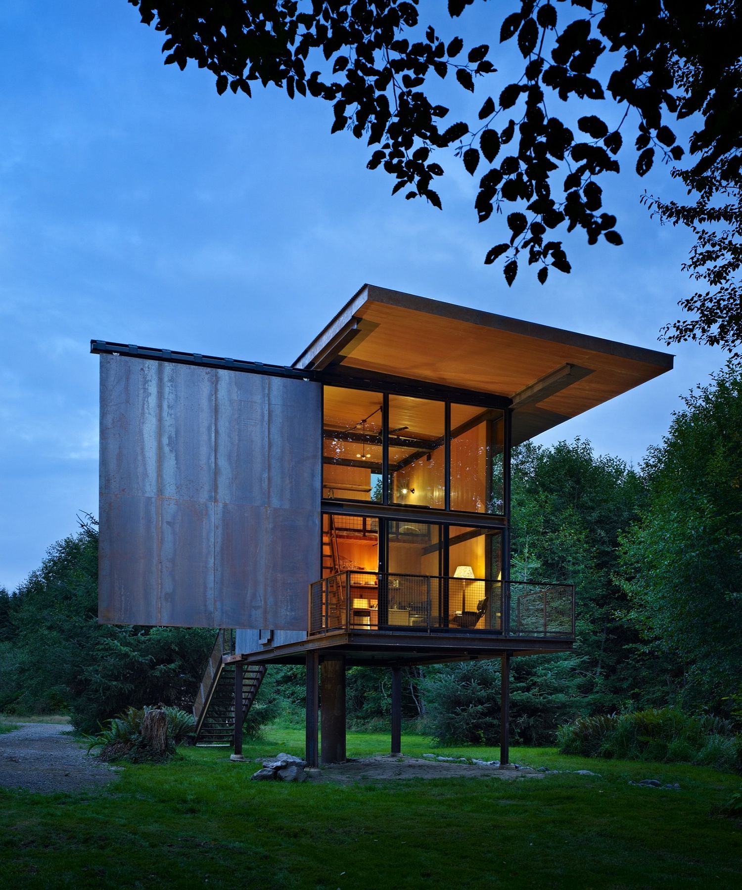 Rough steel and structural insulated panels create a gorgeous forest cabin