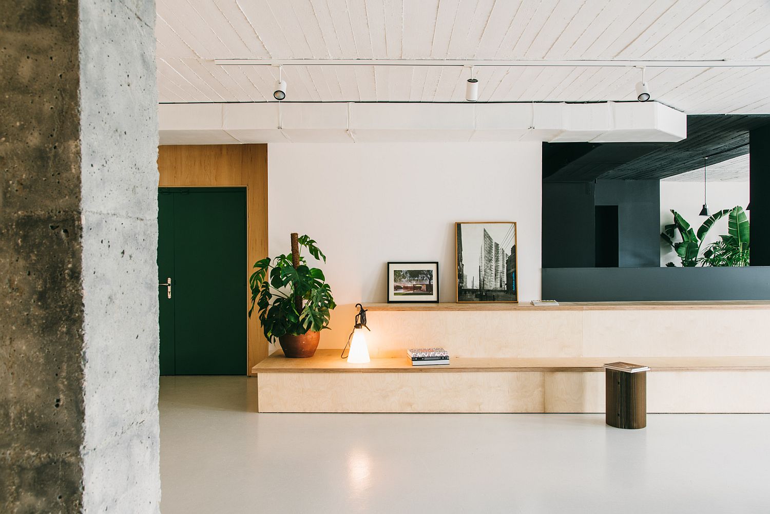 Slim wooden bench provides comfortable sitting space inside the office