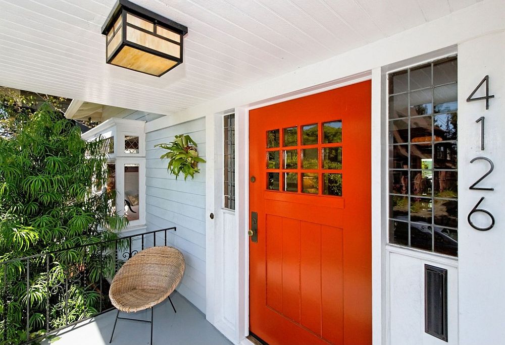 Small and stylish front porch in white with orange door