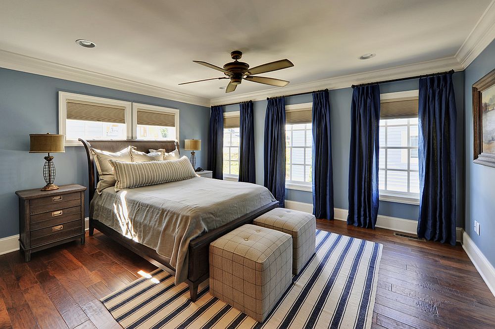 Spacious and light-filled traditional bedroom with gorgeous blue curtains