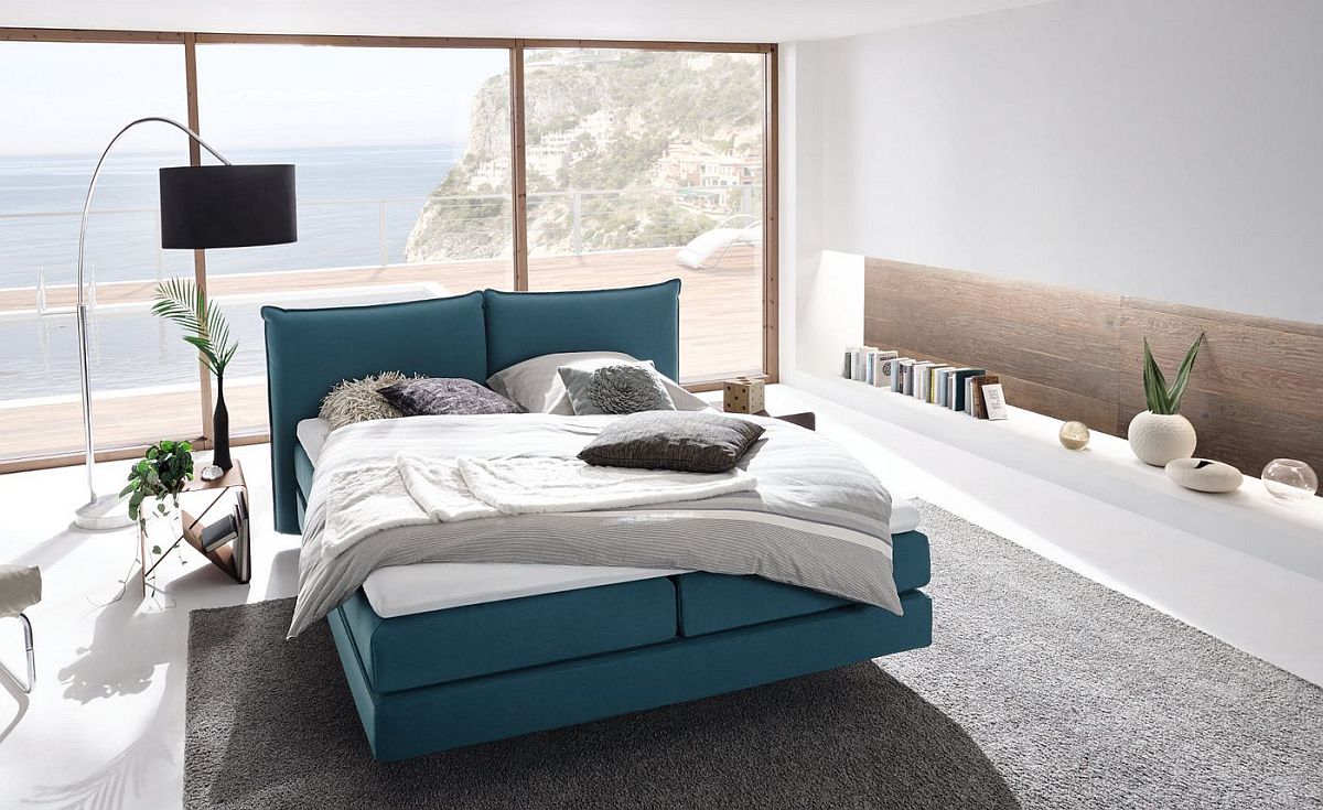 Stylish-bedroom-with-lovely-floor-lamp-blue-bed-and-smart-shelving