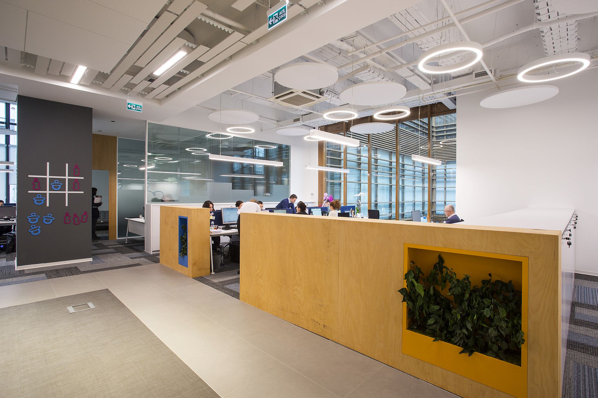 Wooden partitions with niches for indoor plants bring warmth to the contemporary office