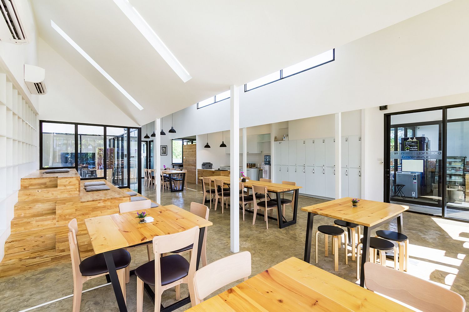 Wooden step-style seating creates an informal sitting space in the co-working area