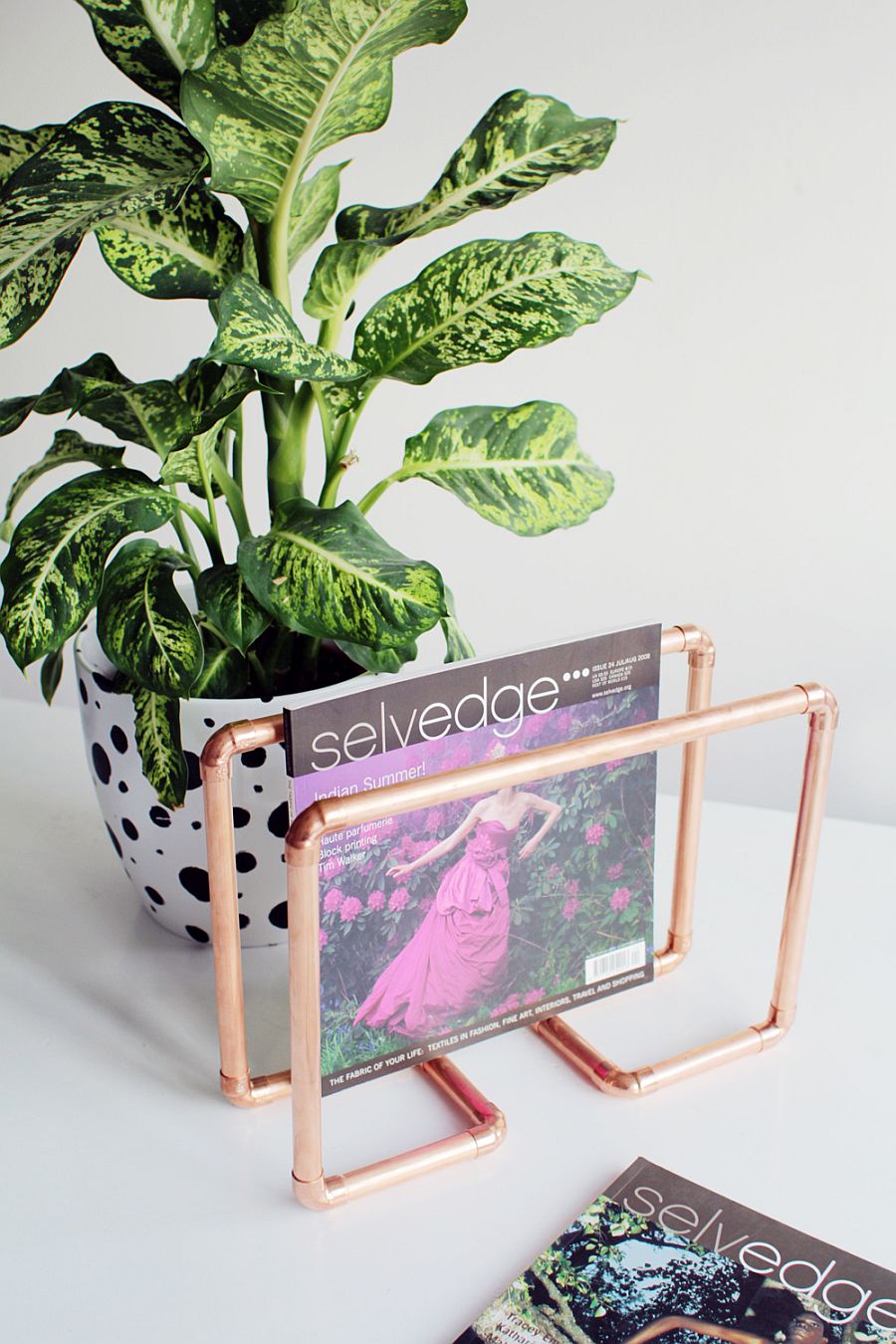 A slim magazine rack in copper for your cool coffee table