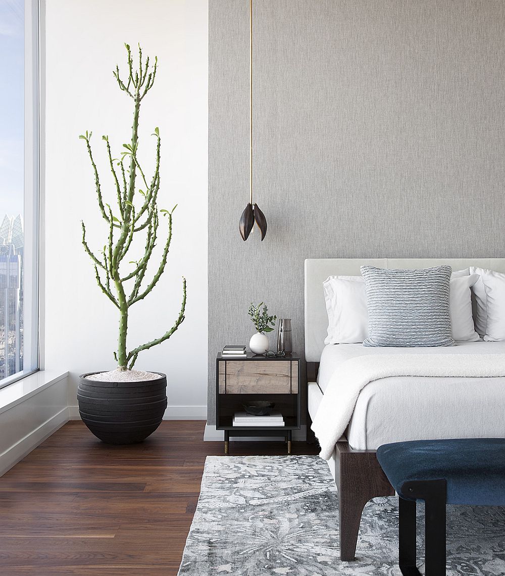 Adding indoor plants to neutral, contemporary bedroom