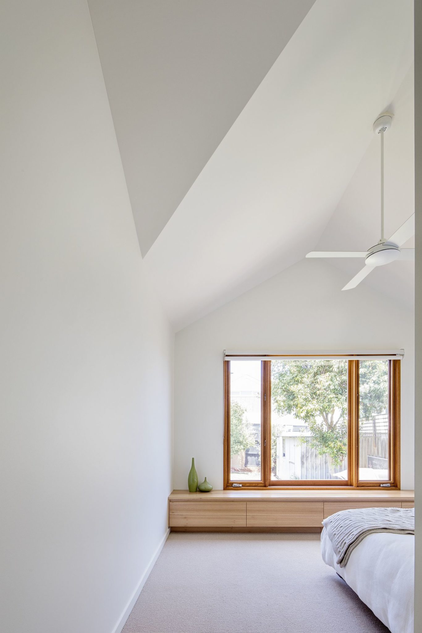 Bedroom in white with sloped ceiling