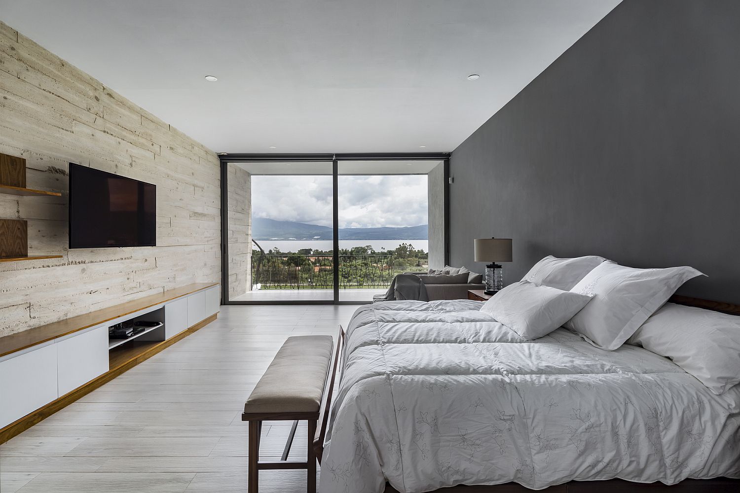 Bedroom of the Lake House with accent wooden wall and a lovely view