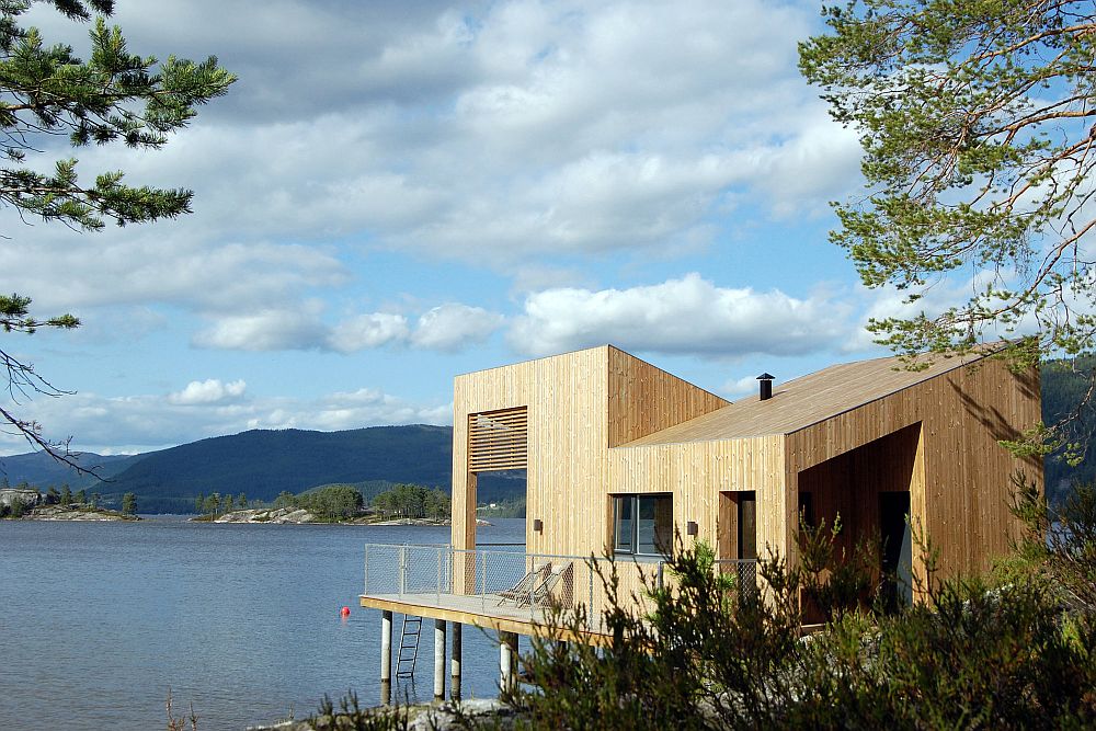 Cabin in pinewood on water's edge