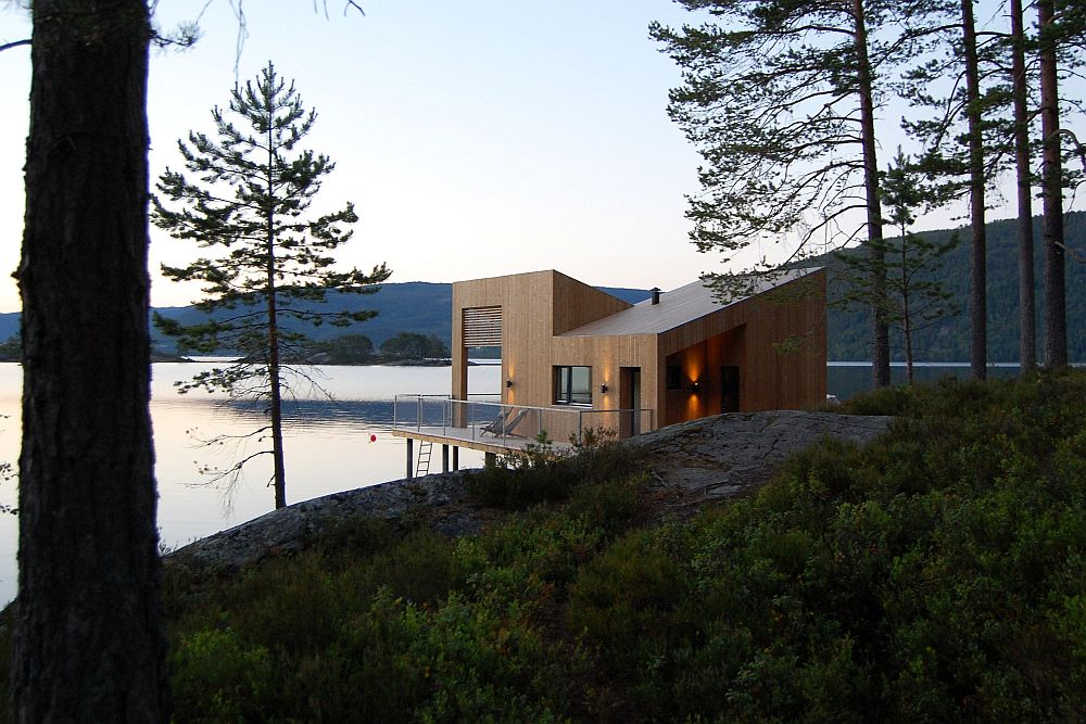 Cabin on stilts on water's edge in Norway