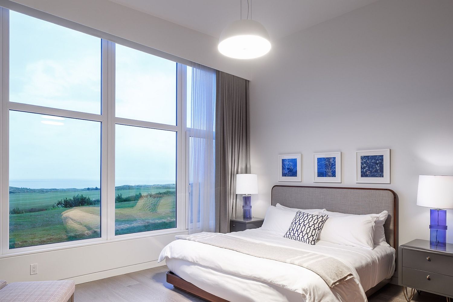 Comfortable modern bedroom in white with an ocean view