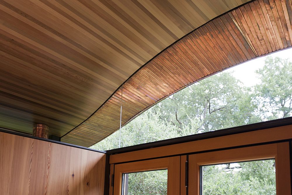 Curved roof of the poolhouse also brings in ample natural light